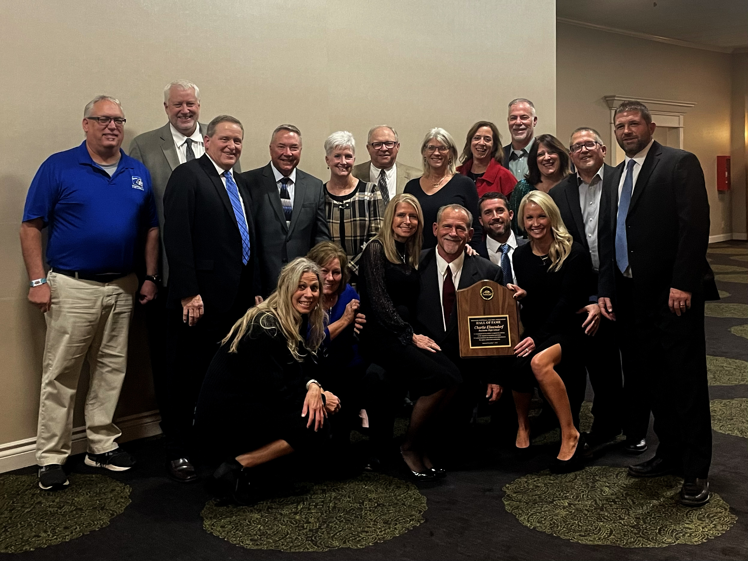 Coach Elmendorf poses with family, friends, and current DHS athletic department staff at his induction ceremony on December 8. 